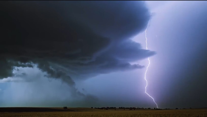 A landscape during the storm while lightning strikes 