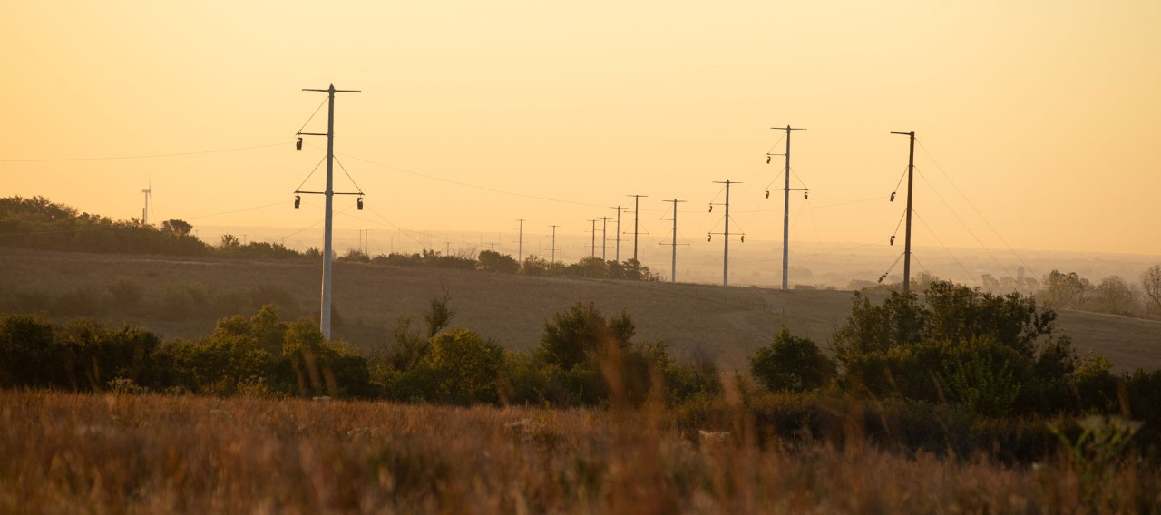 NextEra Energy transmission lines at sunset across rural landscape